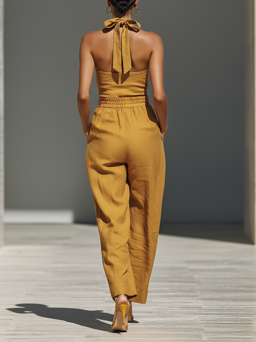 Gabrielle | Mouwloze jumpsuit met gekruiste halslijn en wijde pijpen