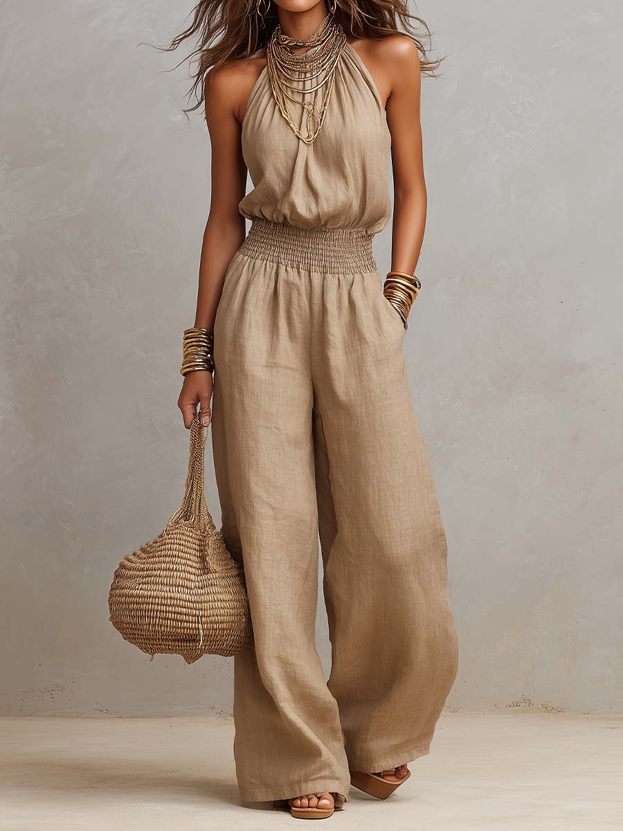 Beige jumpsuit met halternek, geplooide taille en wijde pijpen