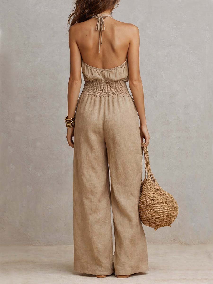 Beige jumpsuit met halternek, geplooide taille en wijde pijpen