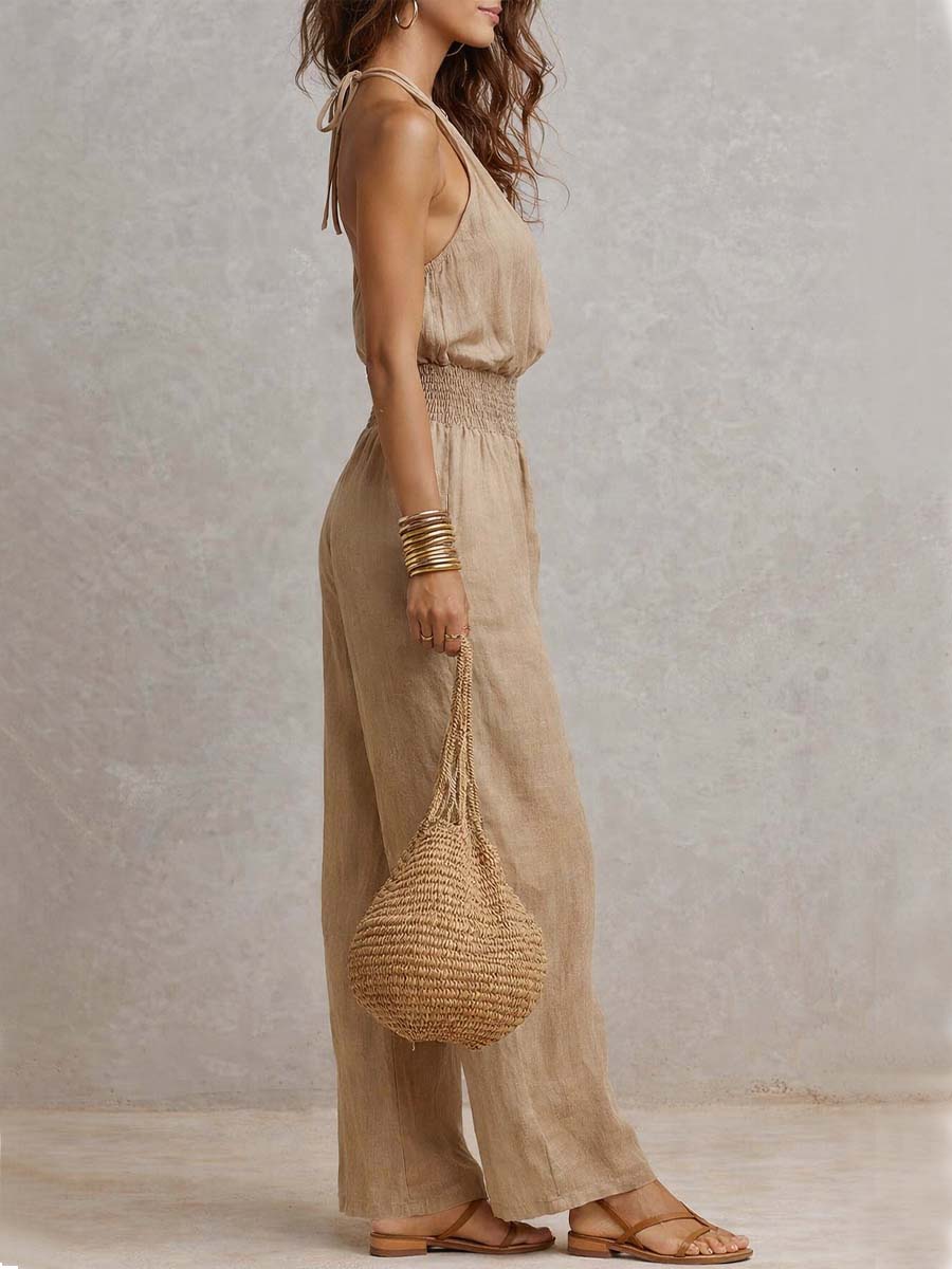 Beige jumpsuit met halternek, geplooide taille en wijde pijpen
