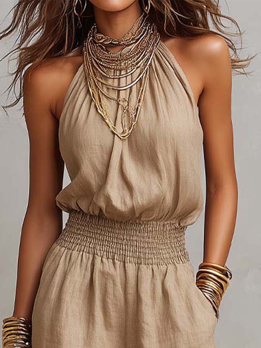 Beige jumpsuit met halternek, geplooide taille en wijde pijpen